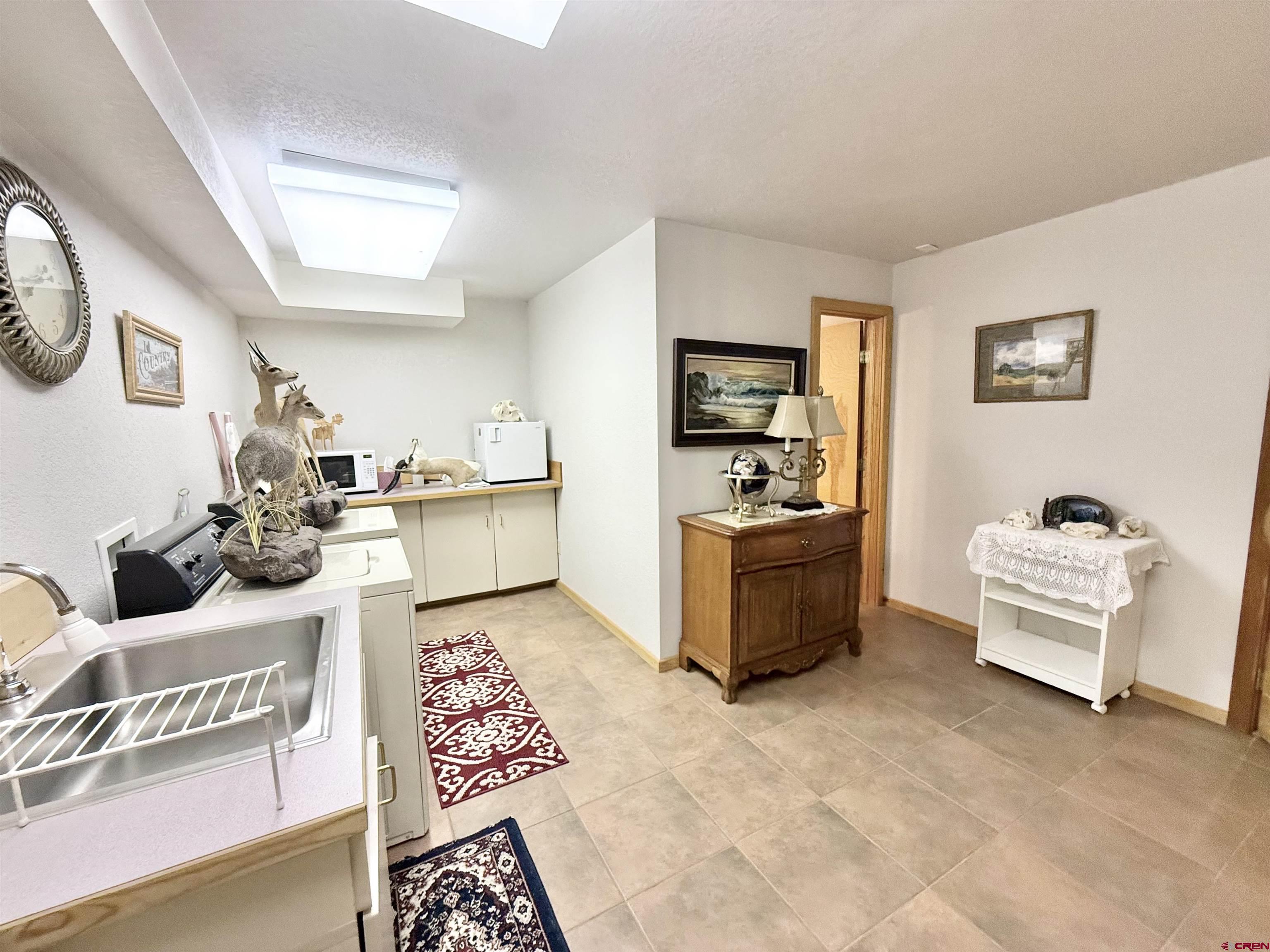 10528 Bostwick Park Road Montrose, CO 81401 - Photo 25 of 43 a living room with furniture and a flat screen tv