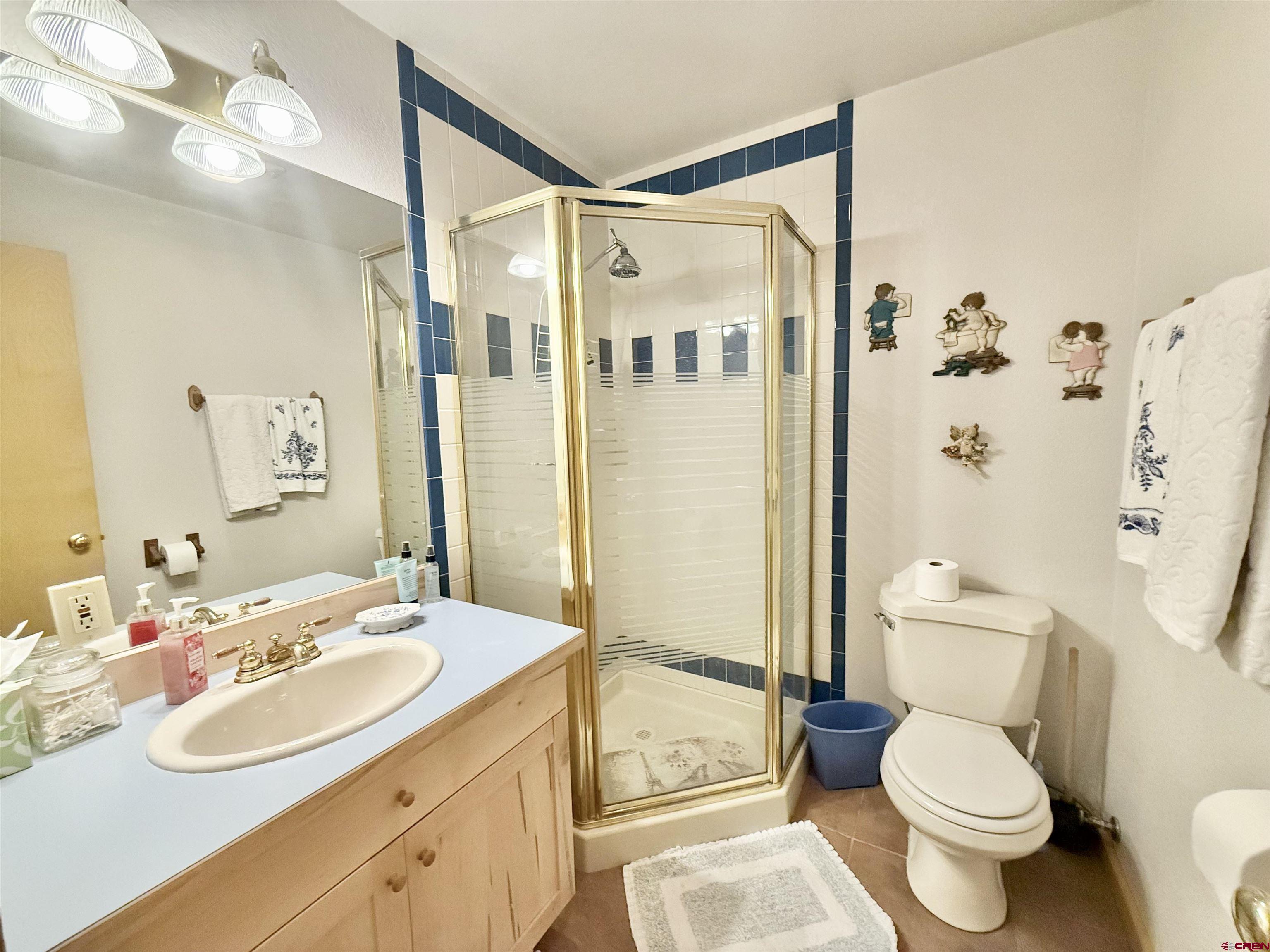 10528 Bostwick Park Road Montrose, CO 81401 - Photo 26 of 43 a bathroom with a sink toilet and shower