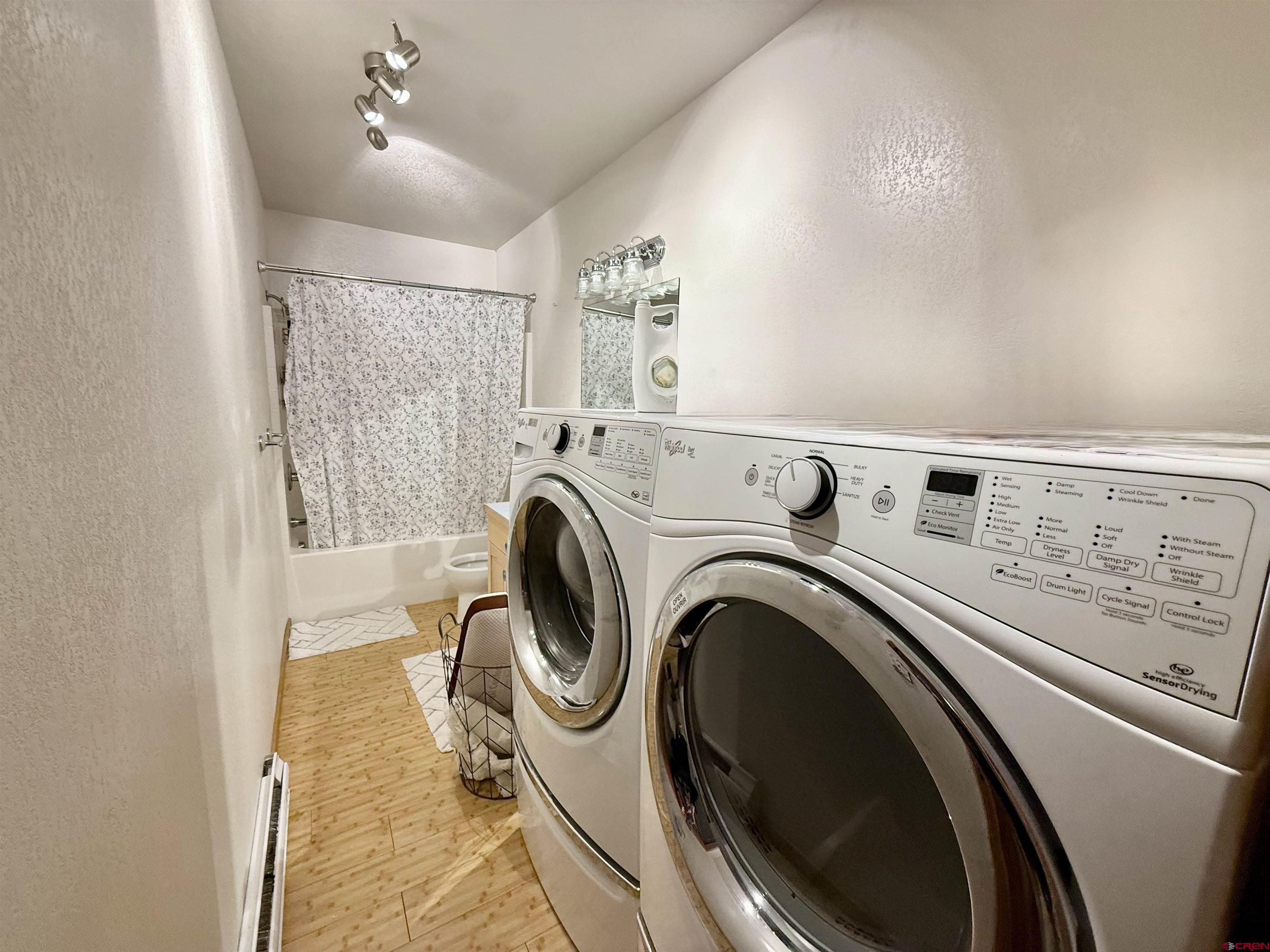 10528 Bostwick Park Road Montrose, CO 81401 - Photo 27 of 43 a view of washer and dryer with kitchen in the background