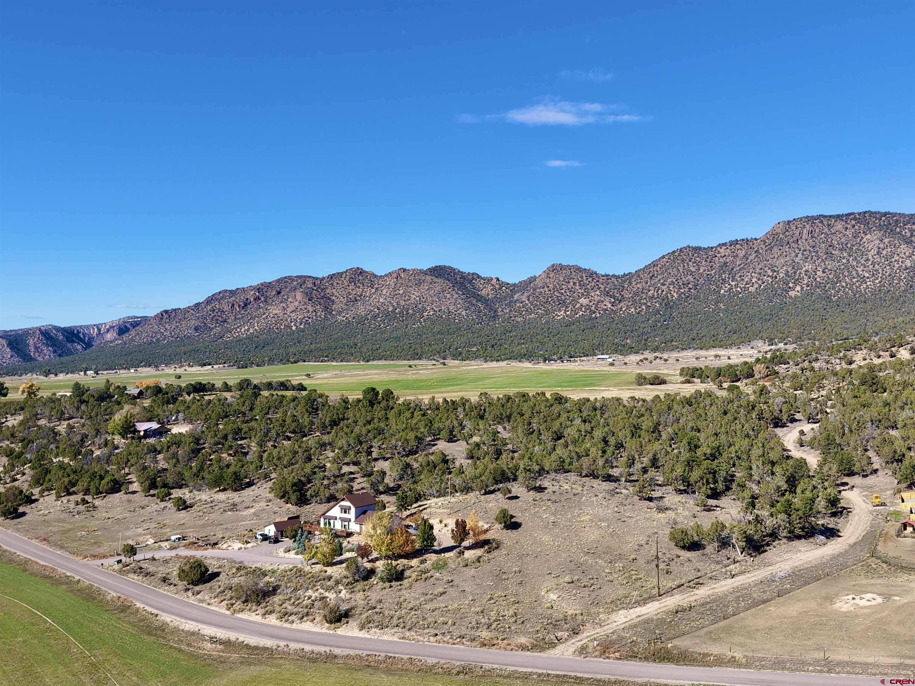 10528 Bostwick Park Road Montrose, CO 81401 - Photo 41 of 43 a view of a lake with a mountain