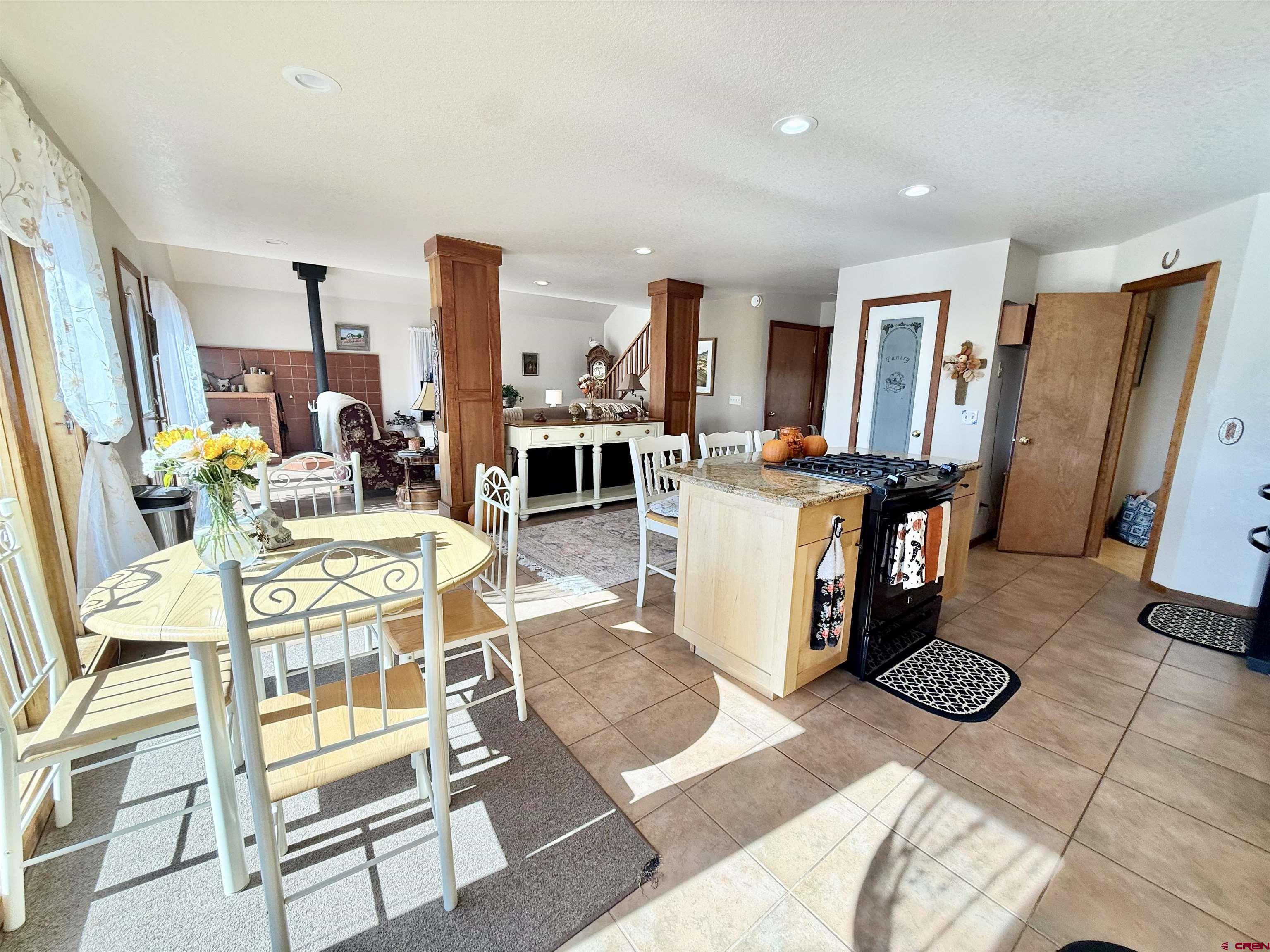 10528 Bostwick Park Road Montrose, CO 81401 - Photo 7 of 43 a living room with fireplace furniture and a table