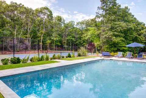 a view of a swimming pool with an outdoor space and seating area
