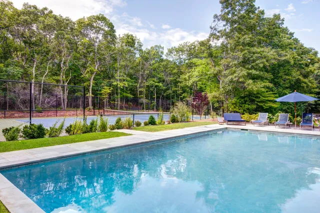 a view of a swimming pool with an outdoor space and seating area
