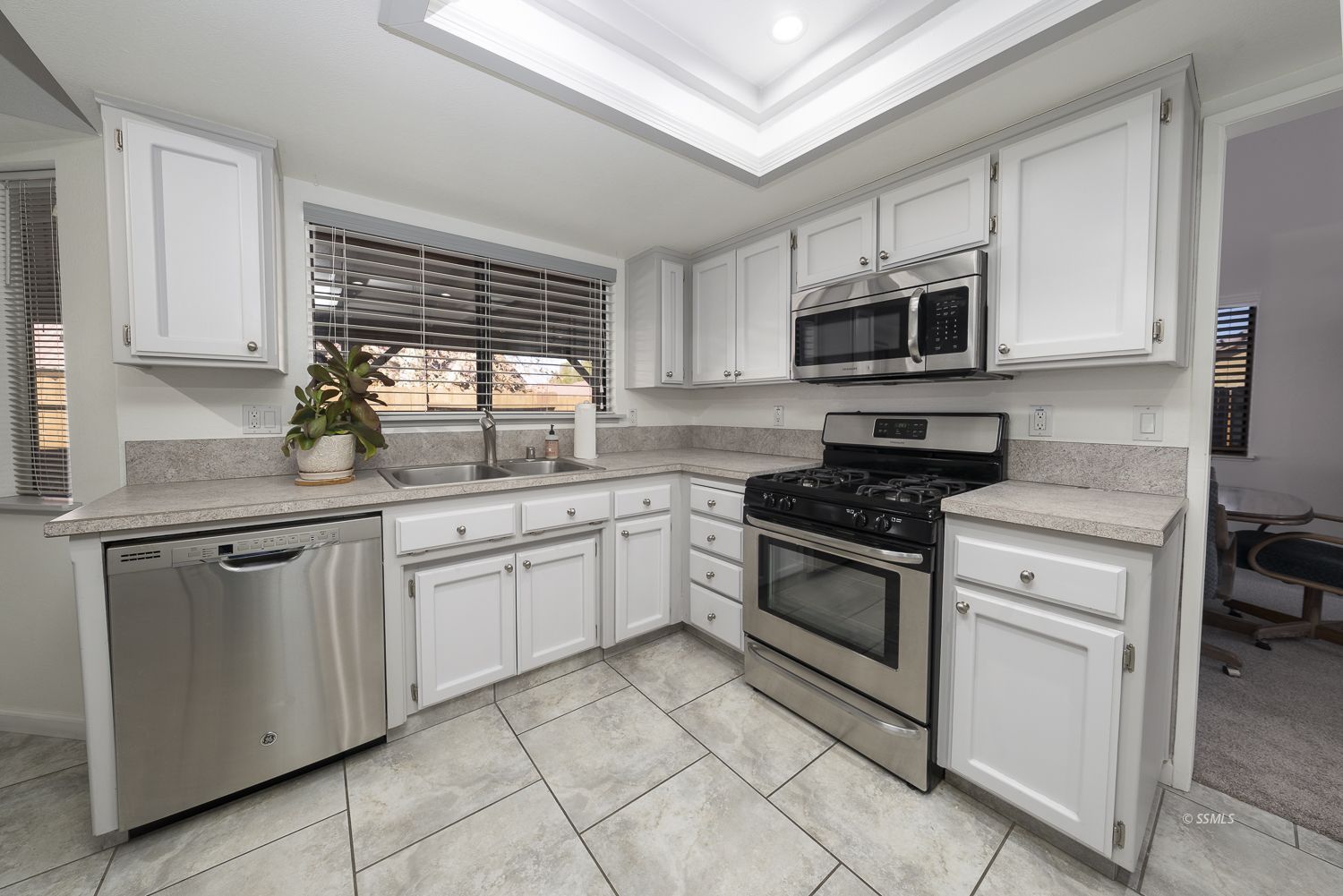 418 Mt Rainier Place Ridgecrest, CA 93555 - Photo 15 of 45 a kitchen with stainless steel appliances granite countertop white cabinets granite counter tops and a window