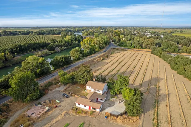 an aerial view of a house with a yard