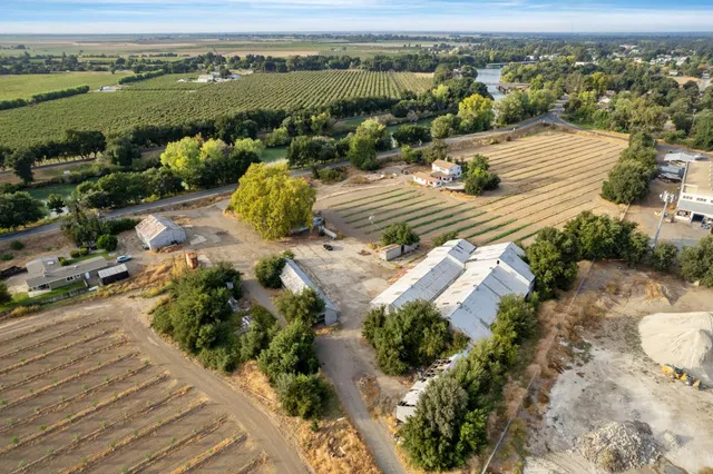 an aerial view of ocean and residential houses with outdoor space