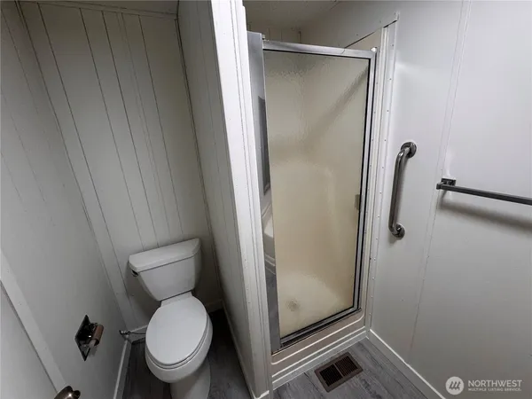 a bathroom with a shower and toilet