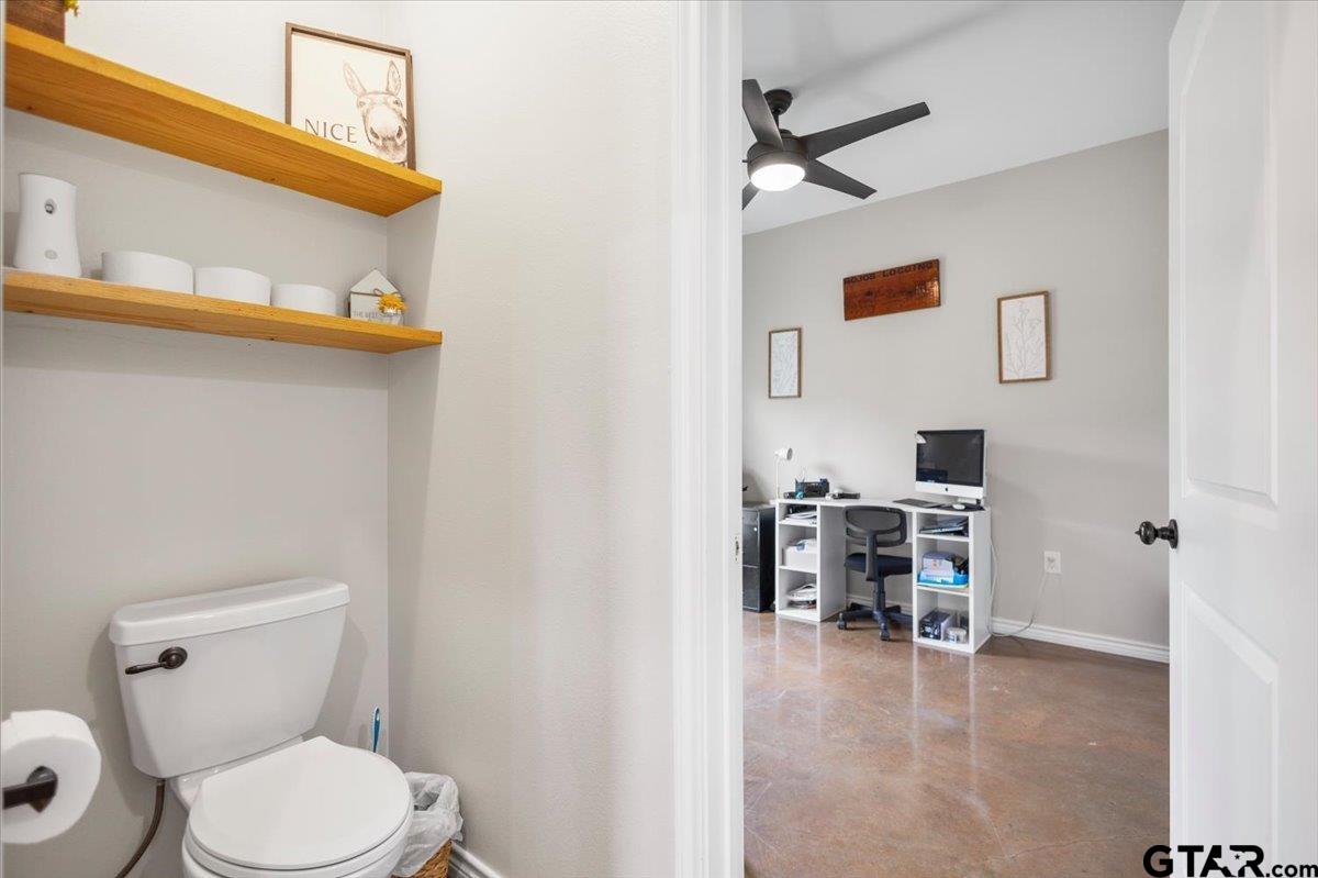 9235 Farm To Market Road 851 Rusk, TX 75785 - Photo 25 of 47 a bathroom with a toilet a sink and a mirror