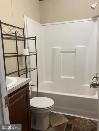 a bathroom with a toilet a sink and bathtub