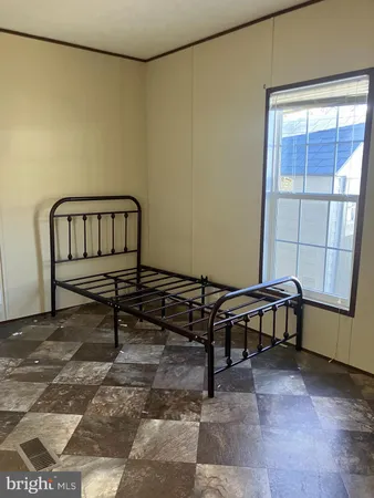 a living room with a table chair and a window