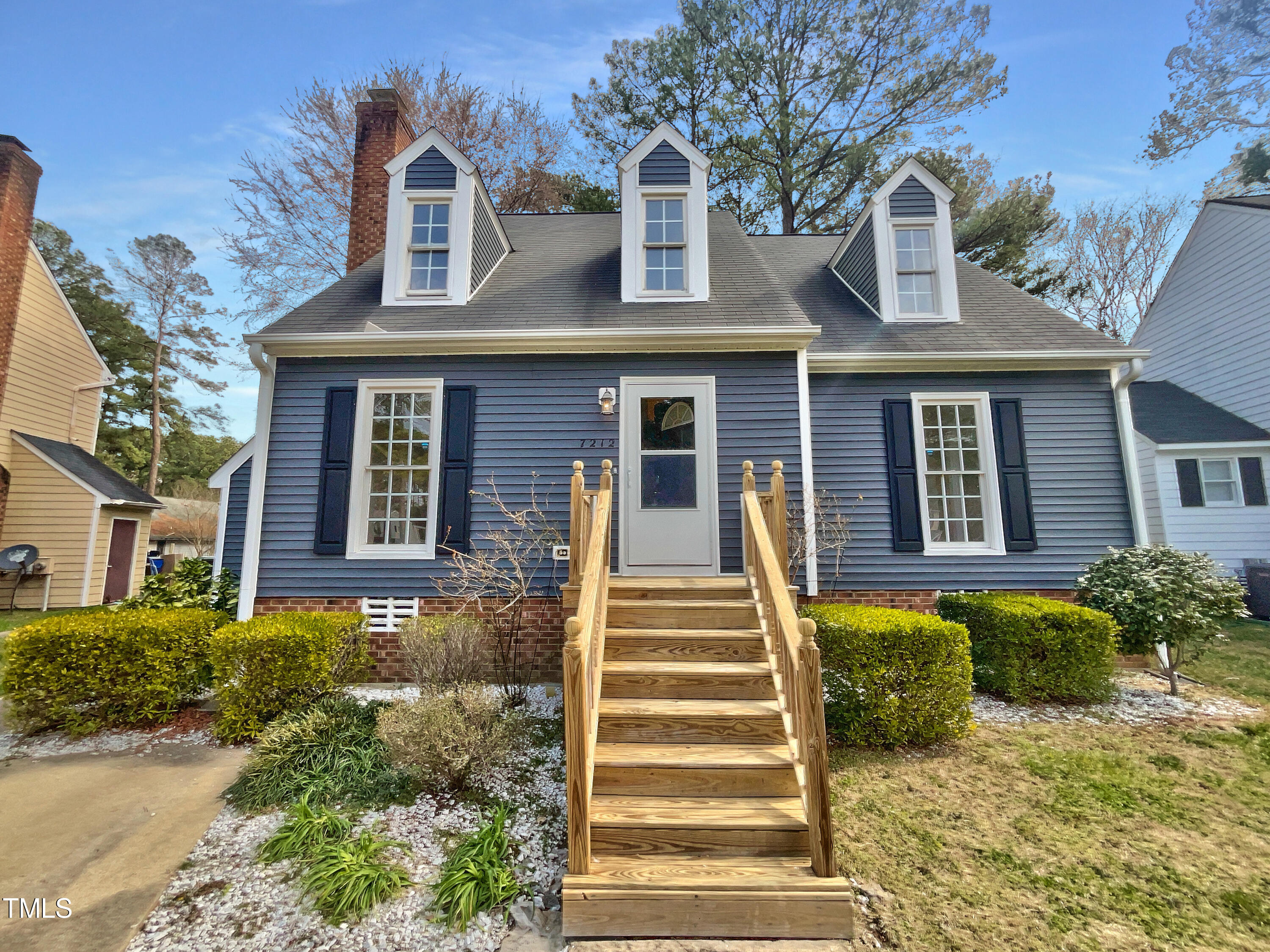 7212 Ewing Place Raleigh, NC 27616 - Photo 1 of 19 a front view of a house with a garden