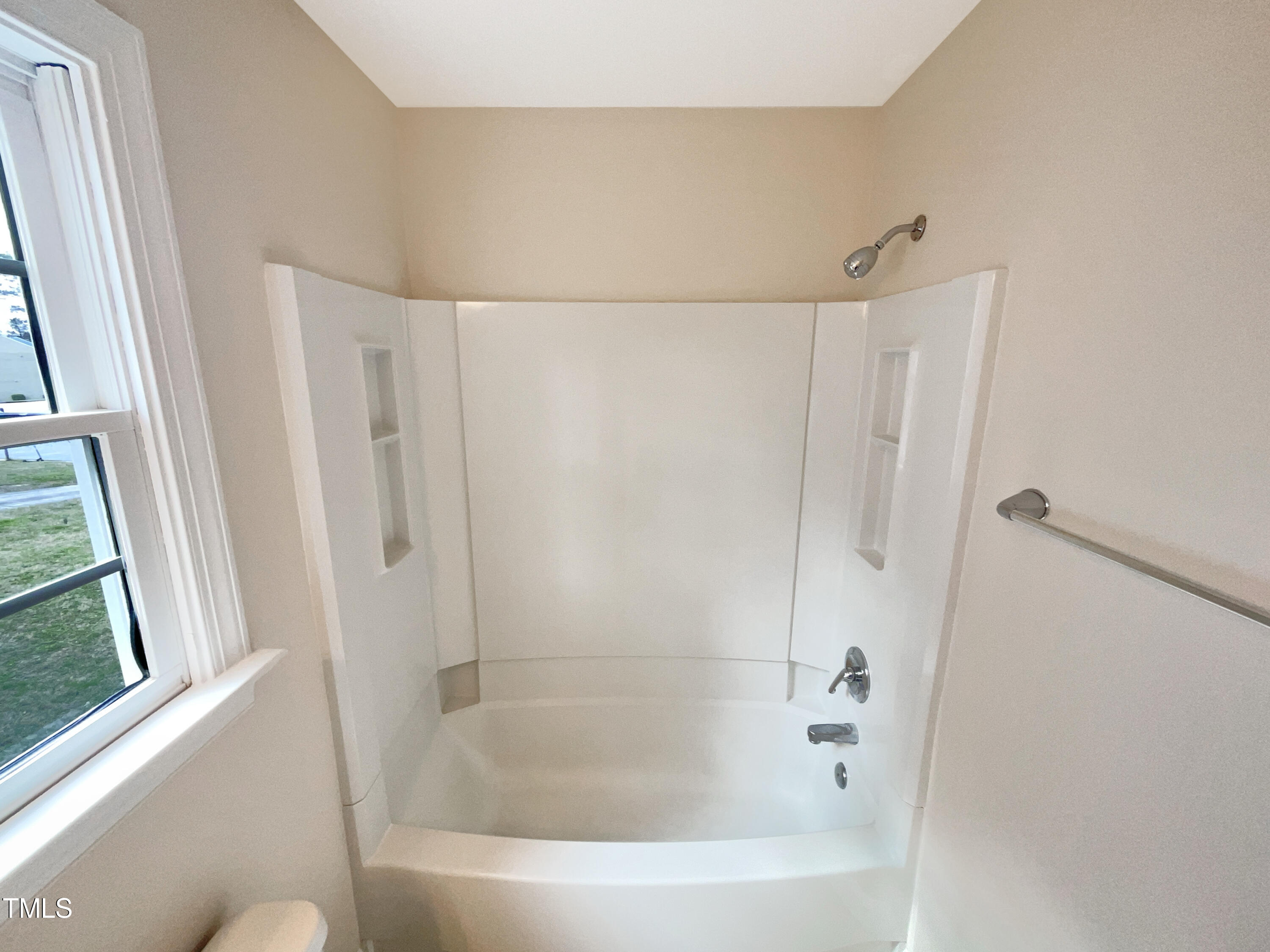 7212 Ewing Place Raleigh, NC 27616 - Photo 11 of 19 a bathroom with a bathtub and a shower