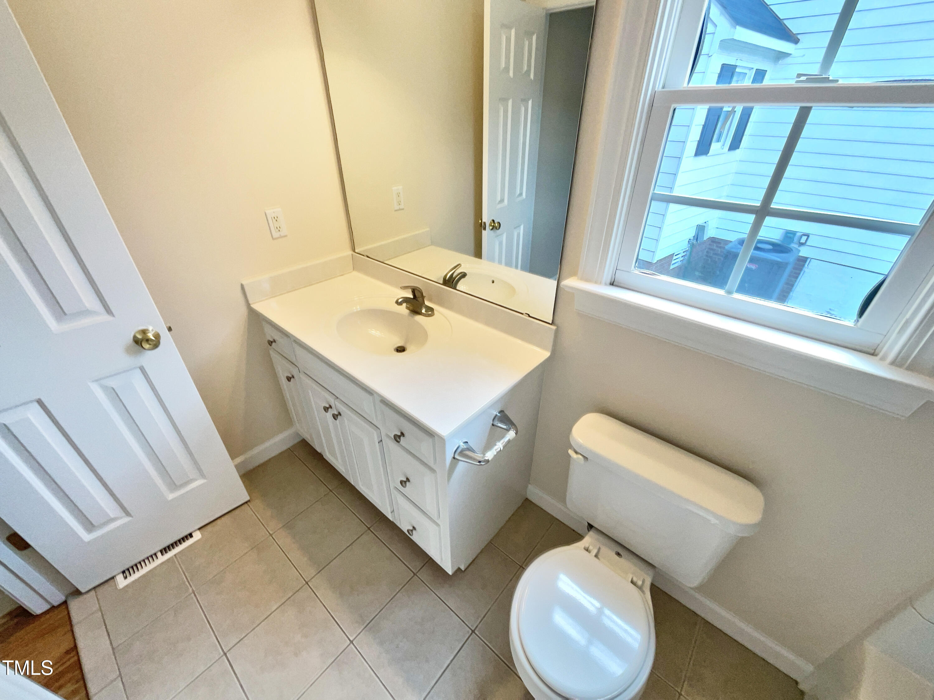 7212 Ewing Place Raleigh, NC 27616 - Photo 12 of 19 a bathroom with a sink toilet and mirror