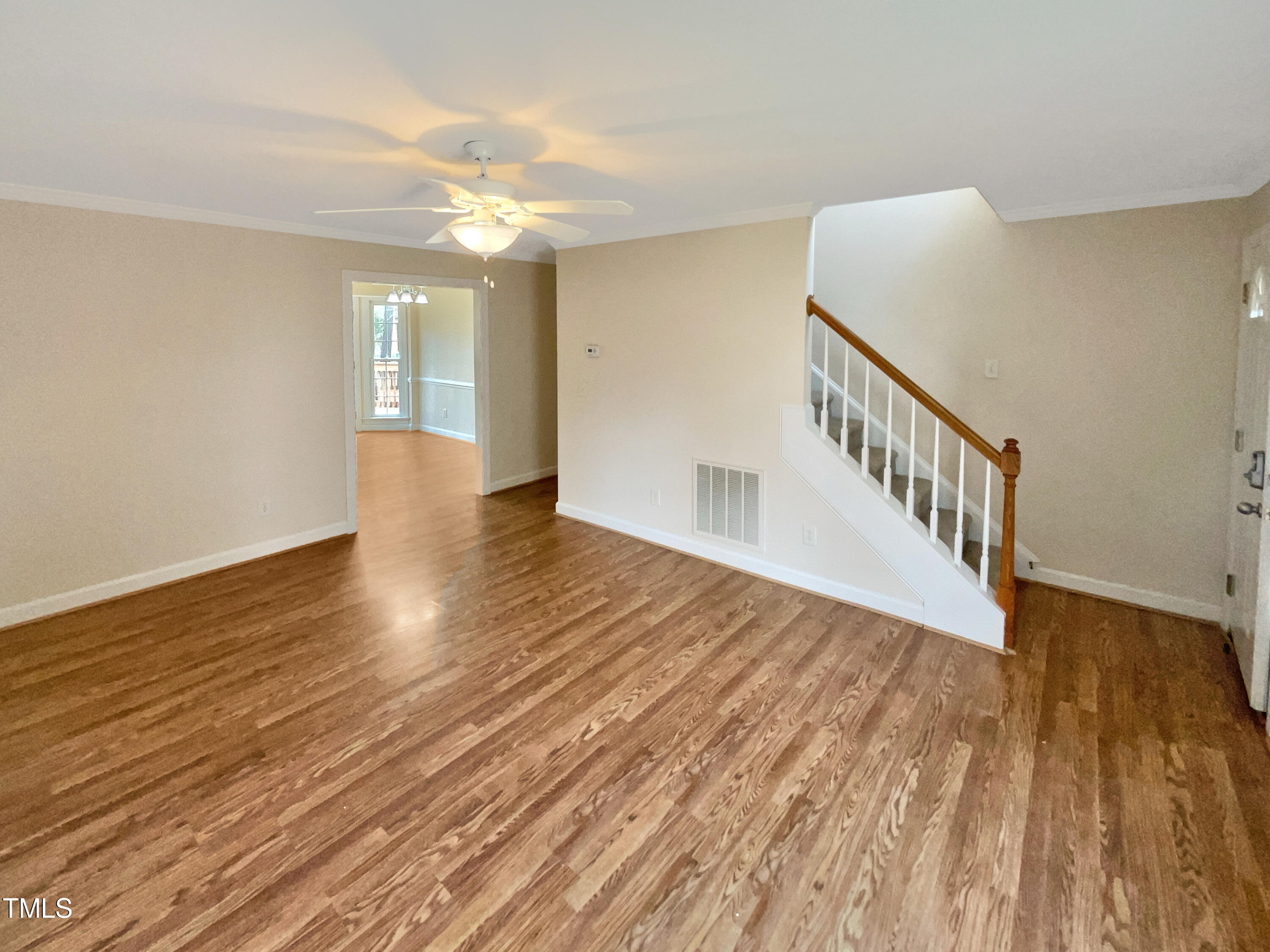 7212 Ewing Place Raleigh, NC 27616 - Photo 3 of 19 a view of an empty room with wooden floor and a window