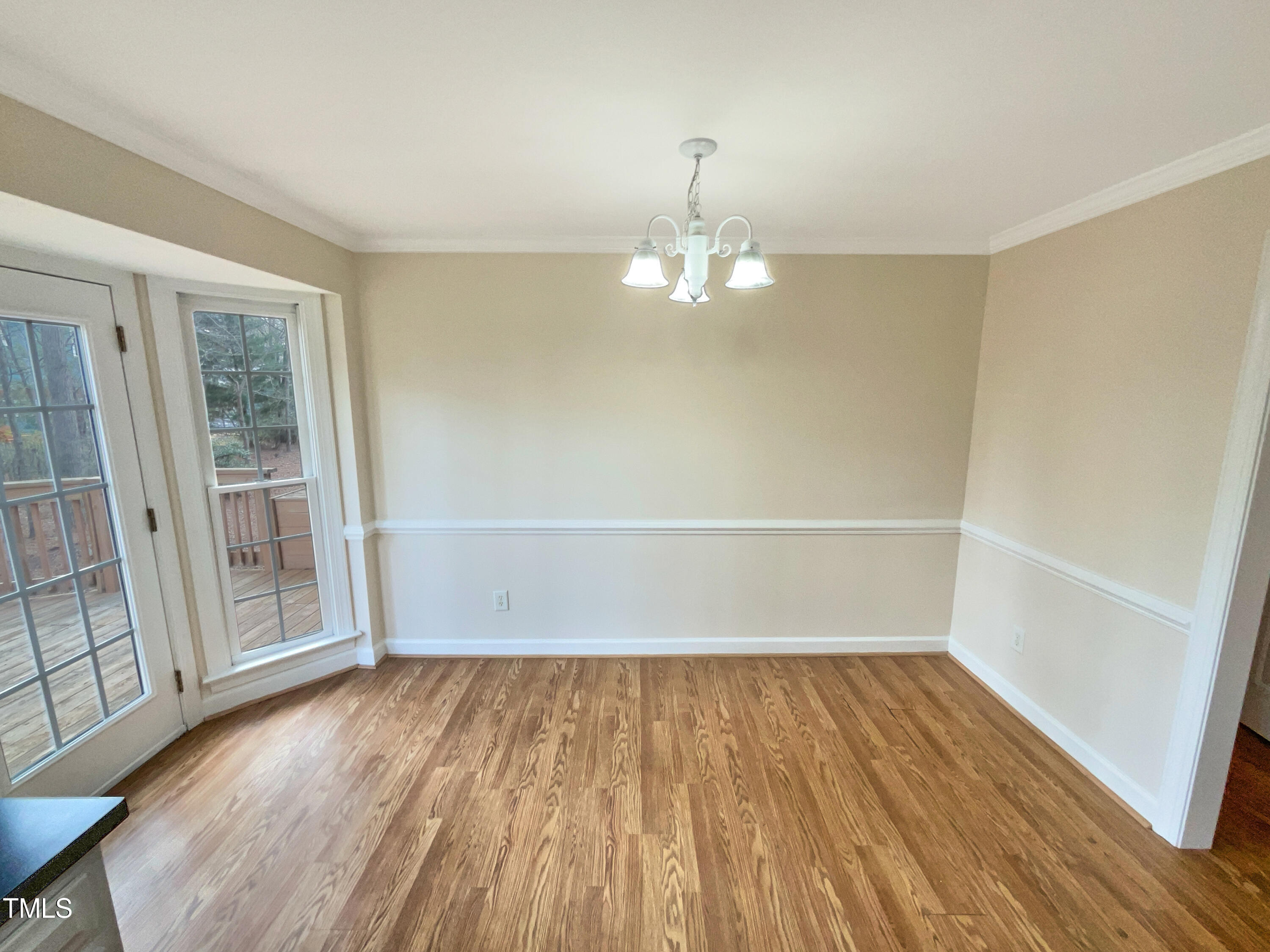 7212 Ewing Place Raleigh, NC 27616 - Photo 7 of 19 wooden floor in an empty room with a window
