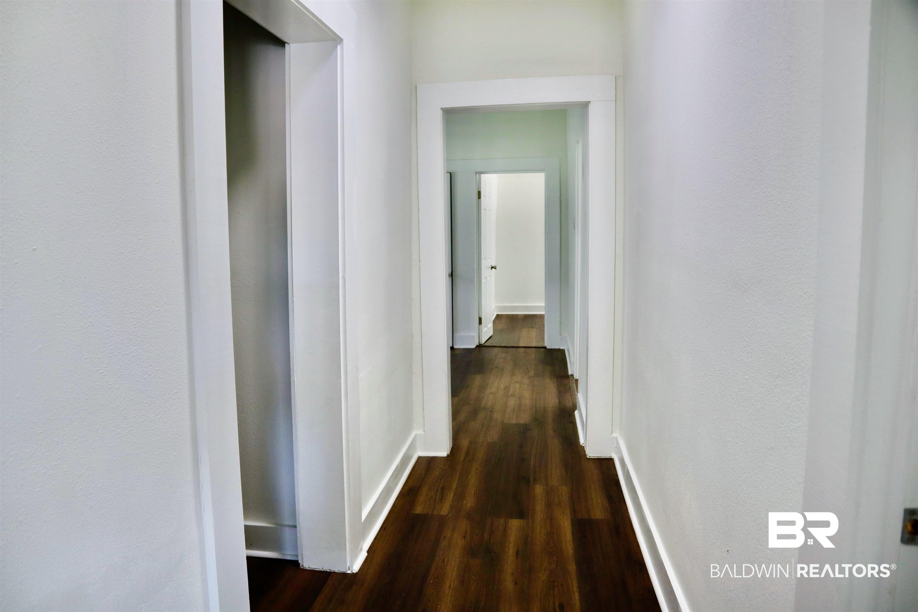 1009 Baltimore Street Mobile, AL 36605 - Photo 8 of 17 Hall with dark wood-type flooring and baseboards