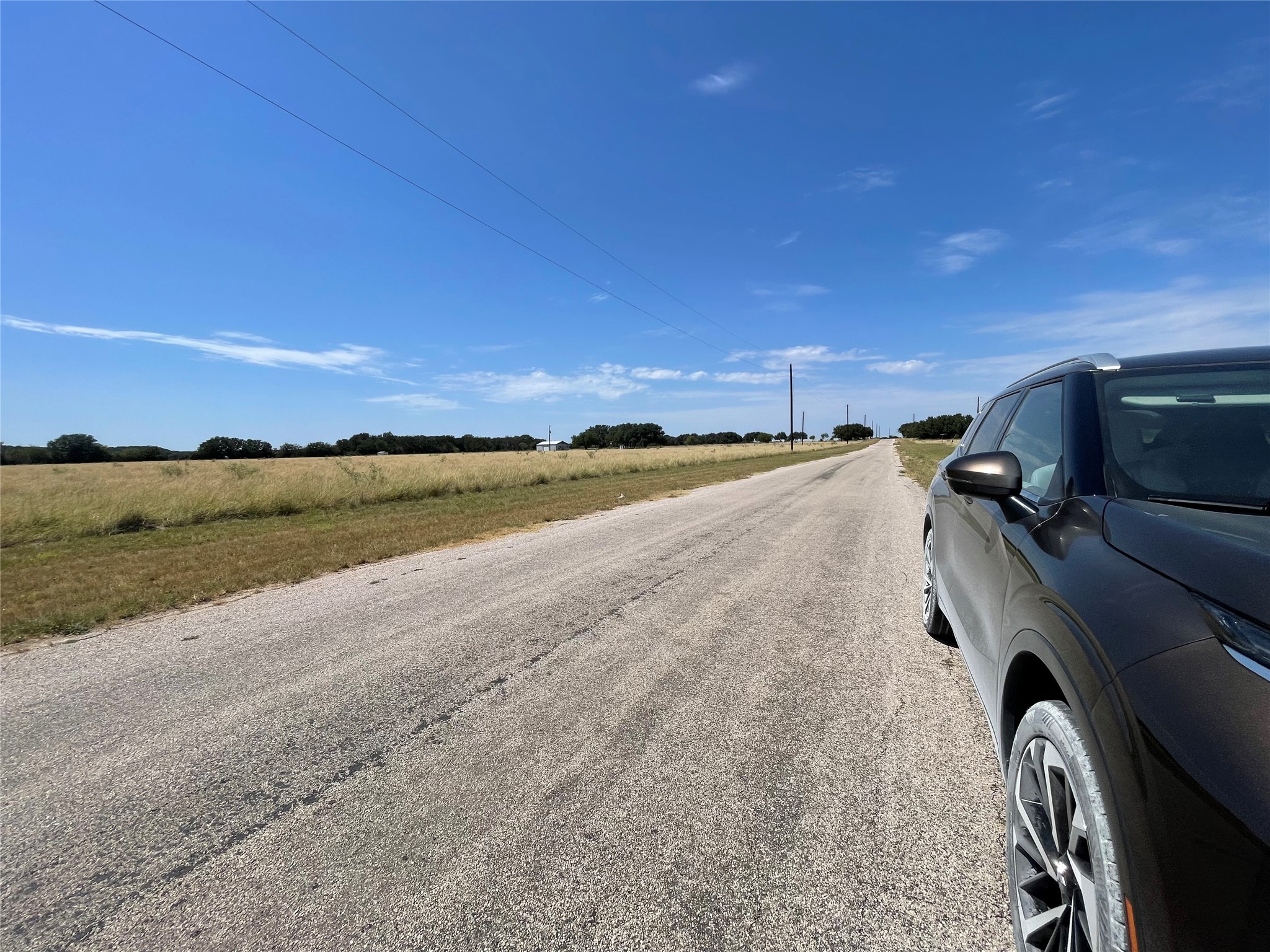Lot 35 Cattle Trail Kempner, TX 76539 - Photo 13 of 20 A long paved road borders wide grassy fields under an open blue sky.