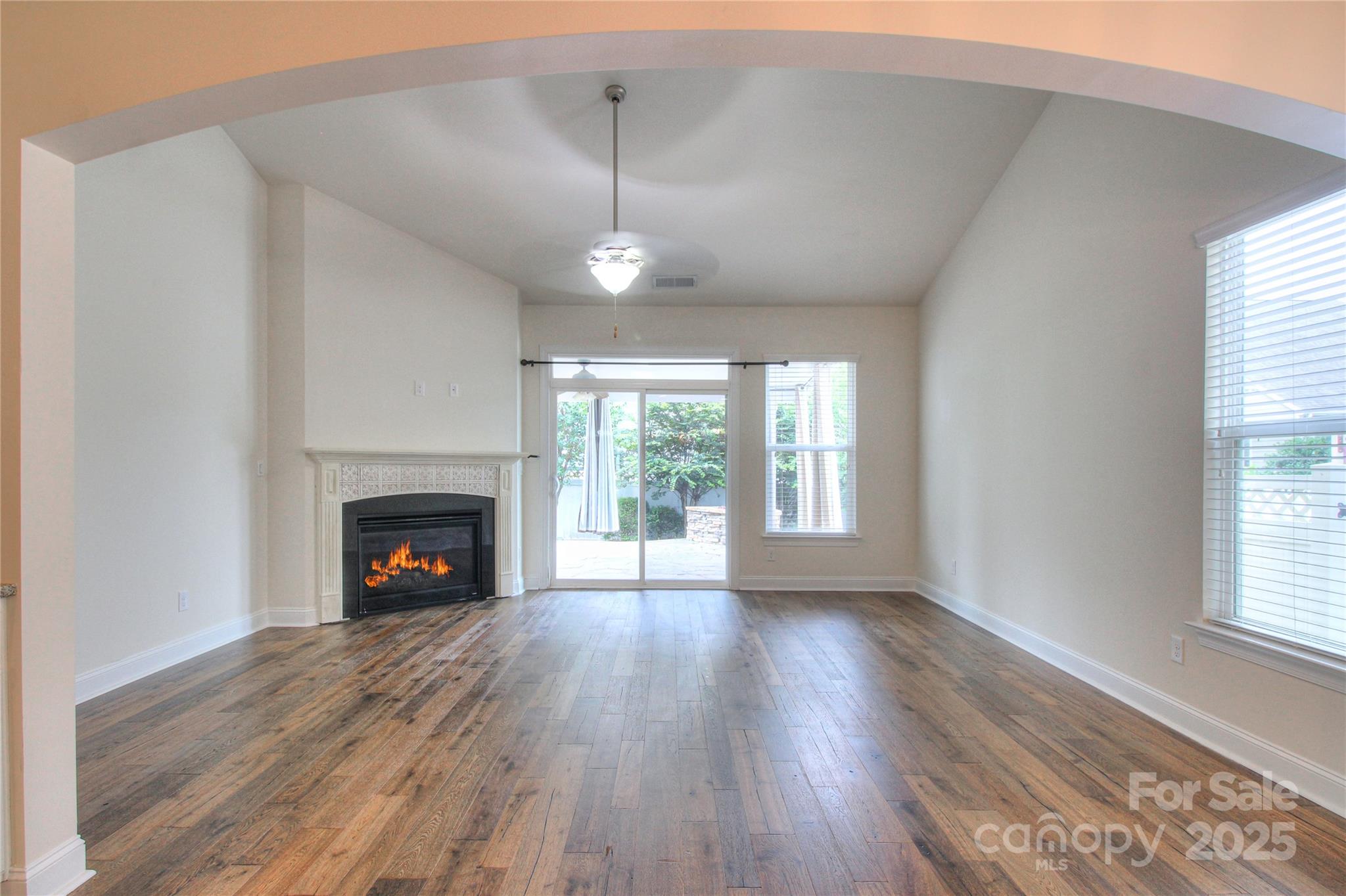 1012 Equipoise Drive Indian Trail, NC 28079 - Photo 12 of 31 a view of an empty room with wooden floor fireplace and a window