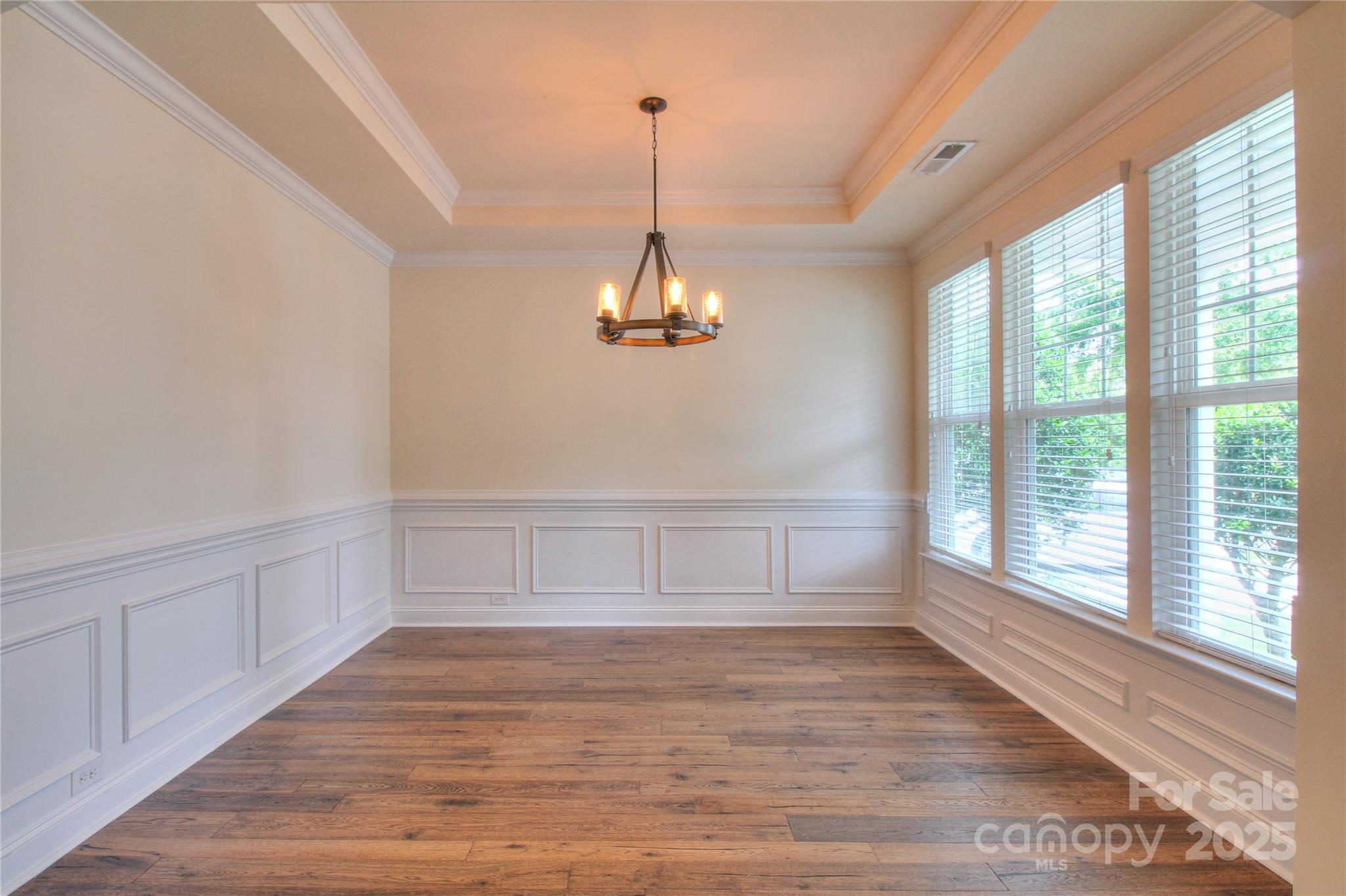 1012 Equipoise Drive Indian Trail, NC 28079 - Photo 13 of 31 a view of an empty room with wooden floor and a window