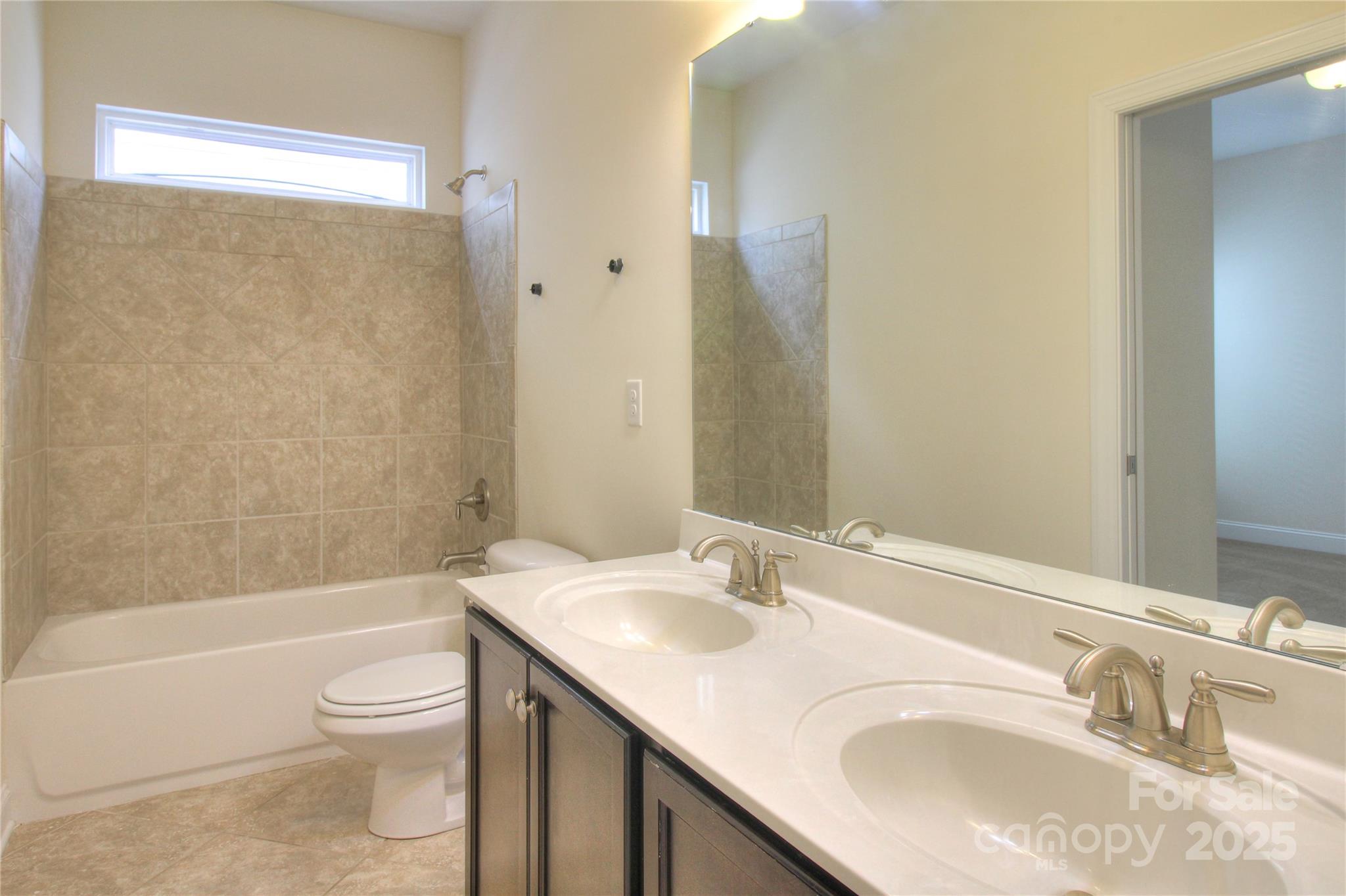 1012 Equipoise Drive Indian Trail, NC 28079 - Photo 23 of 31 a bathroom with a granite countertop sink toilet and shower