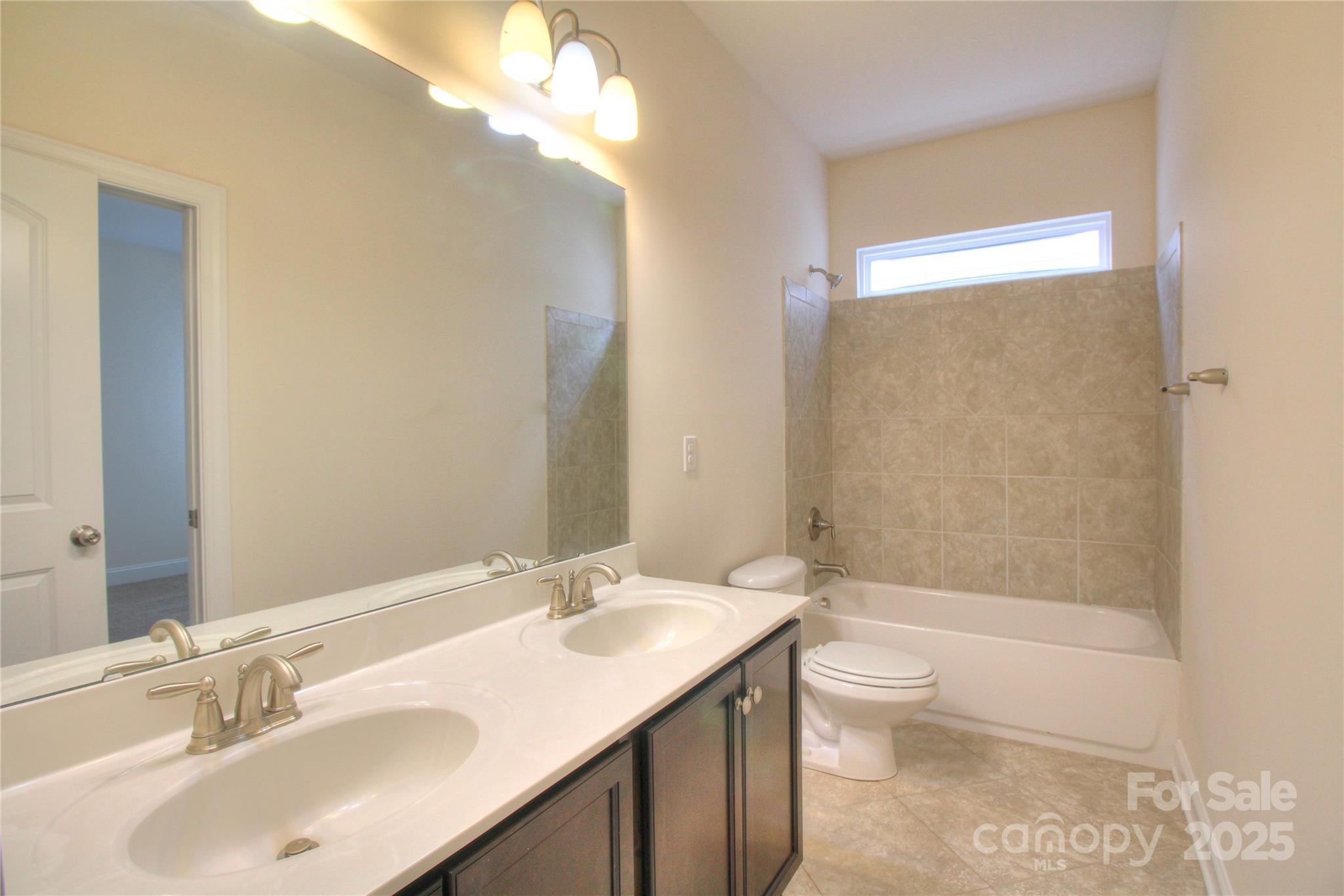 1012 Equipoise Drive Indian Trail, NC 28079 - Photo 26 of 31 a bathroom with a sink a toilet and shower