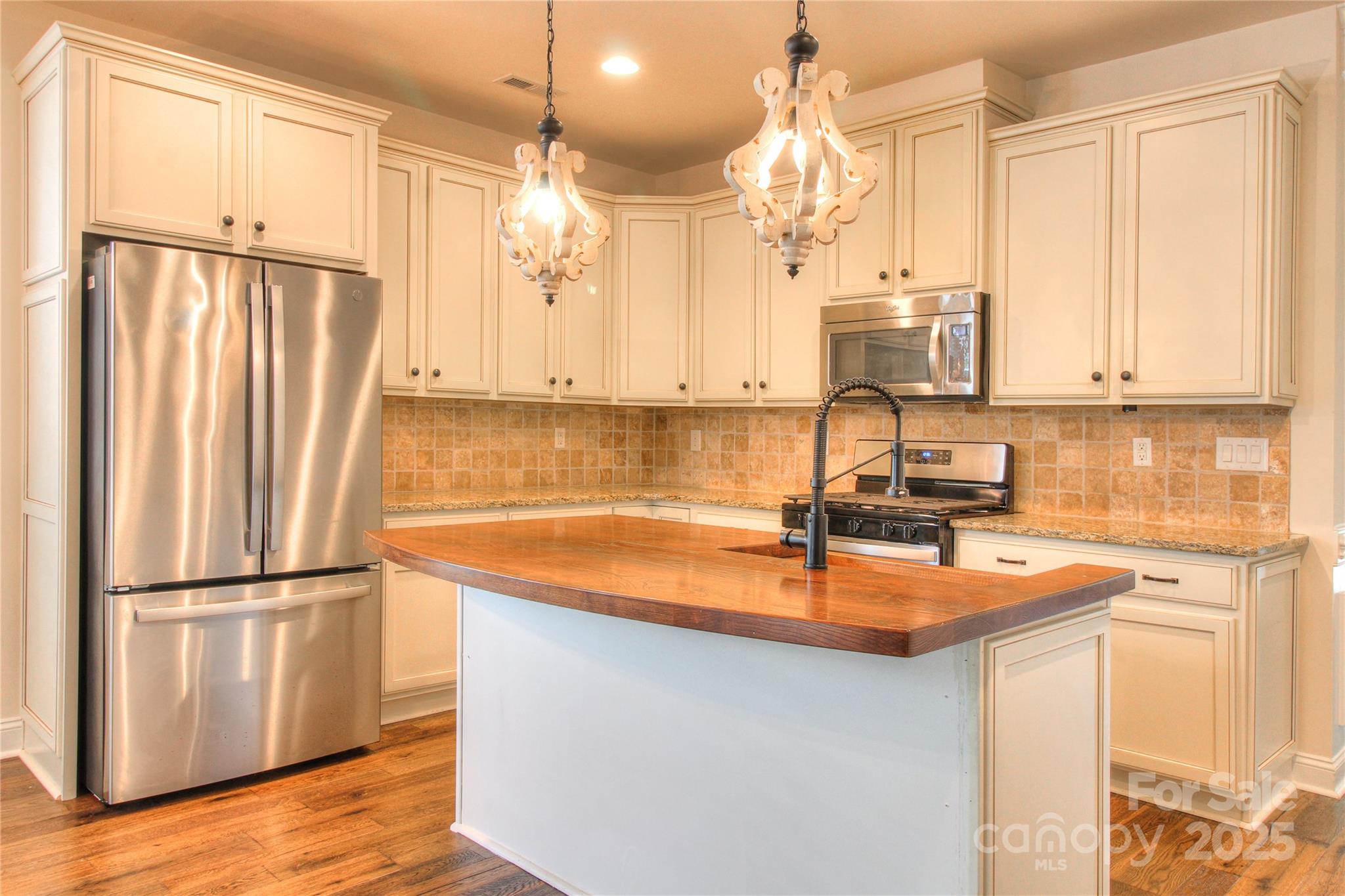 1012 Equipoise Drive Indian Trail, NC 28079 - Photo 6 of 31 a kitchen with stainless steel appliances granite countertop a sink refrigerator and cabinets