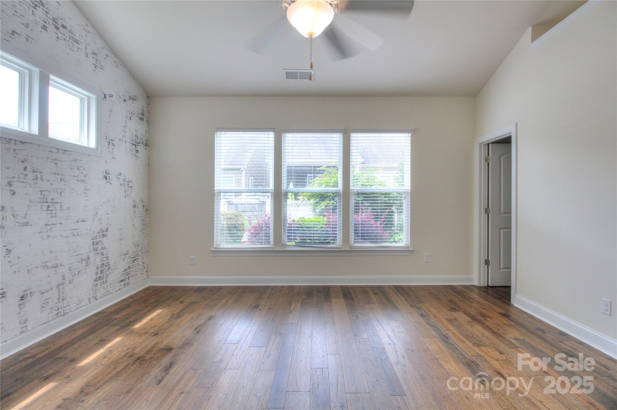 1012 Equipoise Drive Indian Trail, NC 28079 - Photo 10 of 31 an empty room with wooden floor and windows