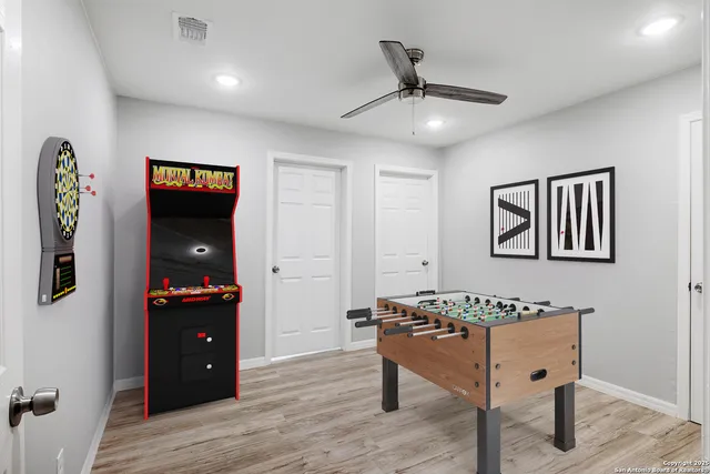 a view of a workspace with furniture and wooden floor