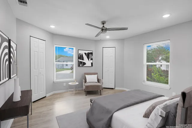 a bedroom with a bed couch and a window