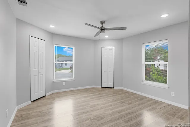 wooden floor in an empty room with a window