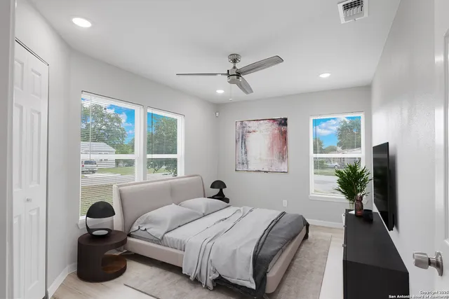 a bed room with a bed and a large window