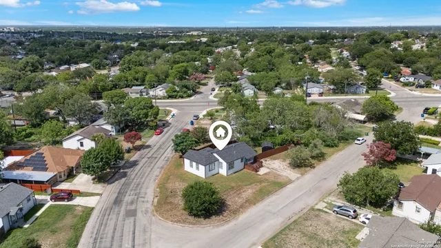 an aerial view of a house with a yard