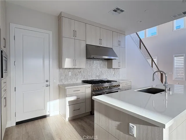 a kitchen with cabinets and a stove