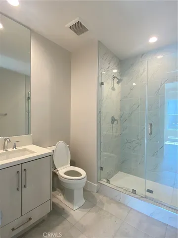 a bathroom with a toilet a sink and shower