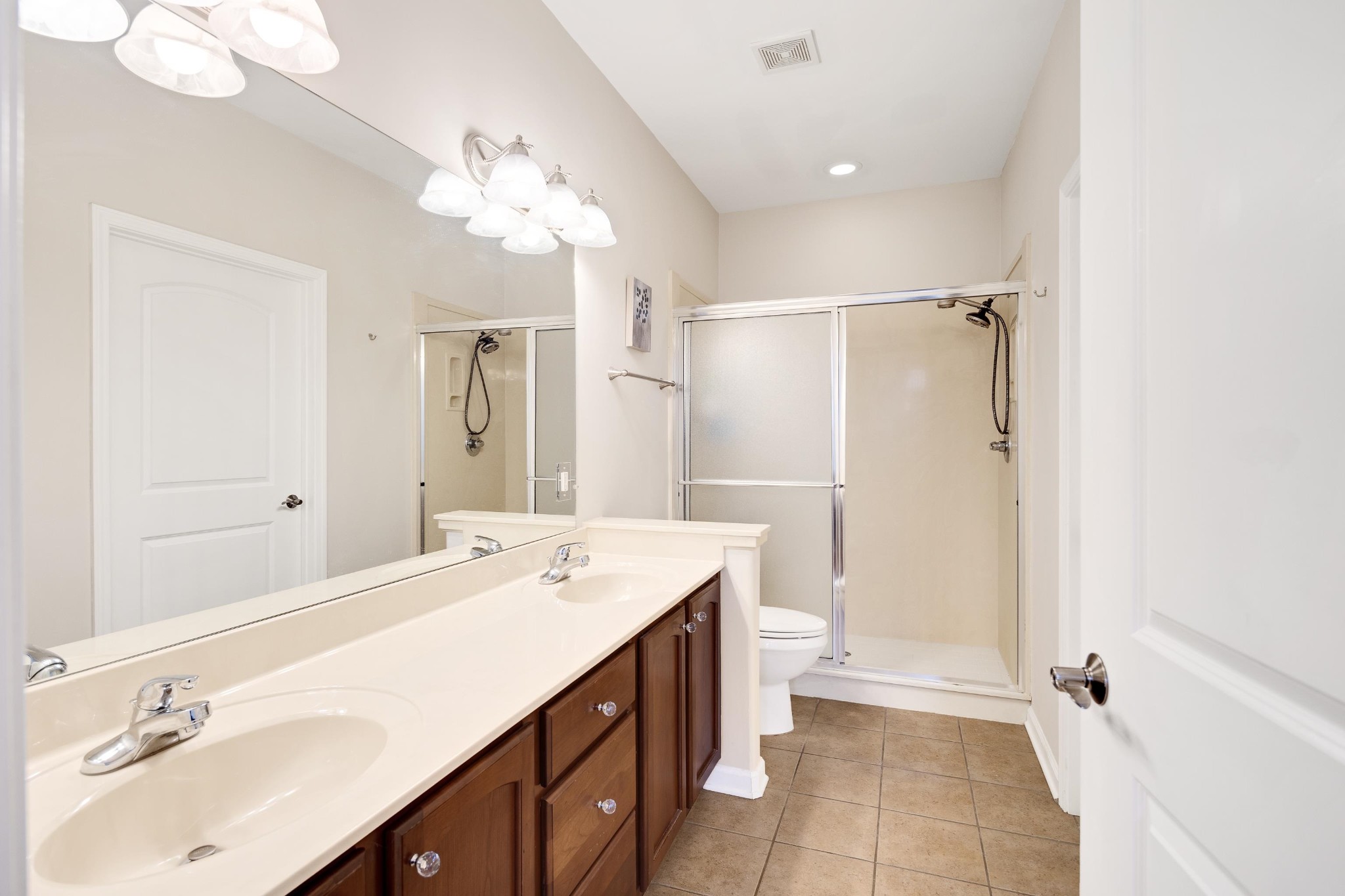 41 Peyton Ridge Drive, Unit 39 Collierville, TN 38017 - Photo 14 of 28 a spacious bathroom with a shower sink double vanity and a mirror