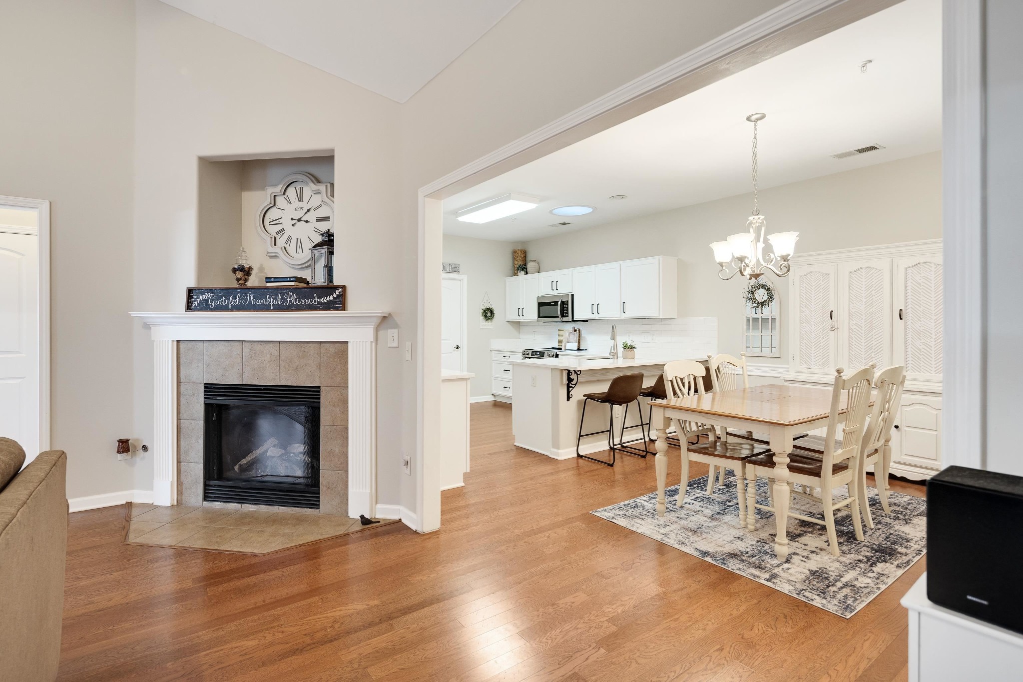 41 Peyton Ridge Drive, Unit 39 Collierville, TN 38017 - Photo 7 of 28 a living room with furniture a fireplace and kitchen view