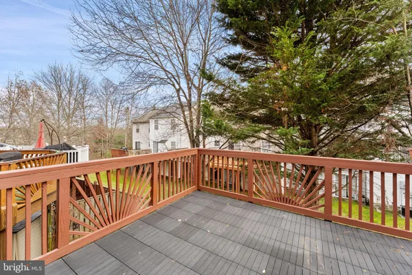 a view of balcony with wooden fence and floor