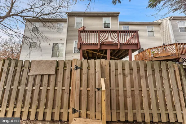 a view of a house with a wooden fence
