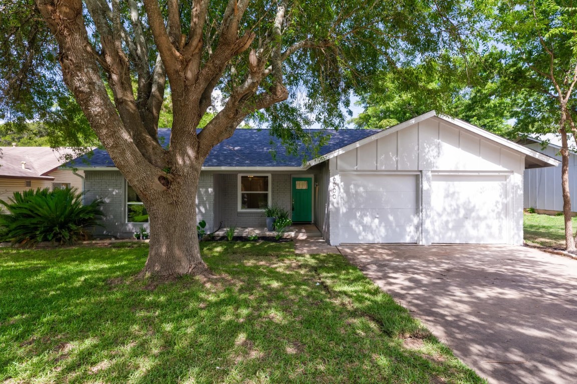 6000 Wagon Bend Austin, TX 78744 - Photo 1 of 1 a house that has a tree in front of the house