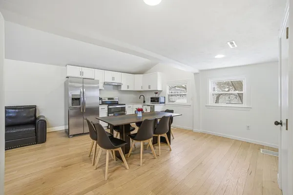 a view of a dining room with furniture and wooden floor