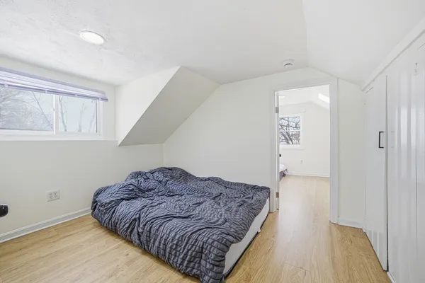 a bedroom with a bed and a window