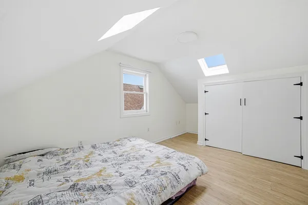 a view of a workspace room with wooden floor and windows