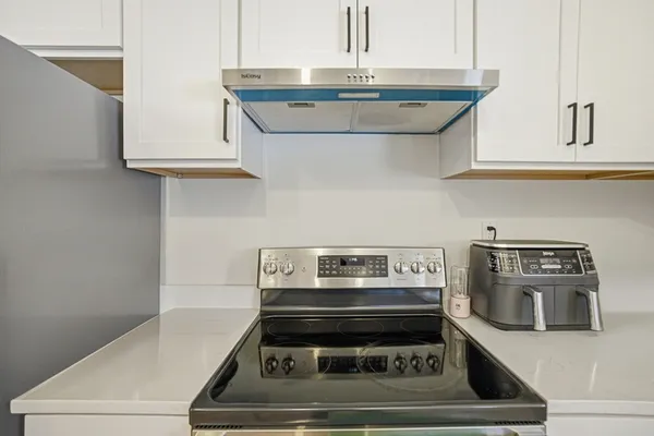 a stove top oven sitting inside of a kitchen