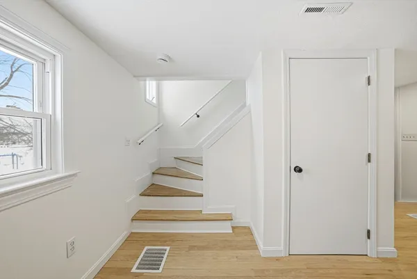 a view of hallway with a white door