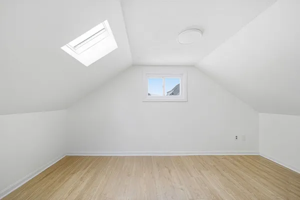 a living room with a bed and dresser