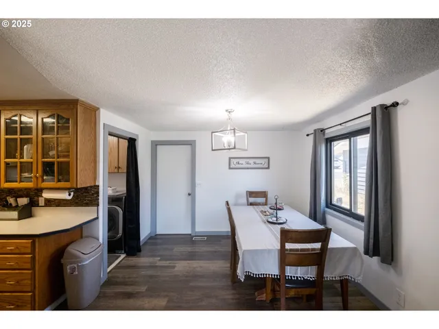 a view of a dining room with furniture and window