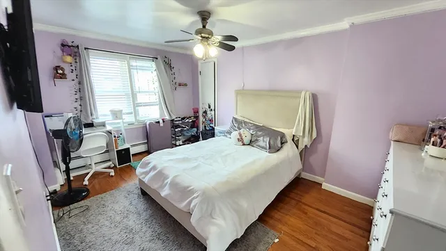 a bed room with a bed tv and a window