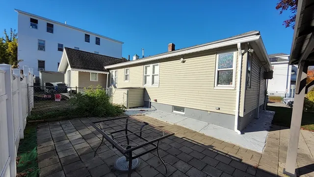 a view of house with backyard and glass windows