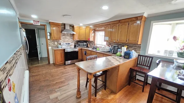a kitchen with a table chairs sink and refrigerator