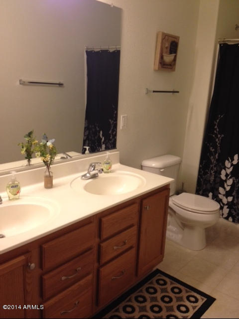 1250 South Rialto, Unit 62 Mesa, AZ 85209 - Photo 16 of 24 a bathroom with a sink toilet and mirror